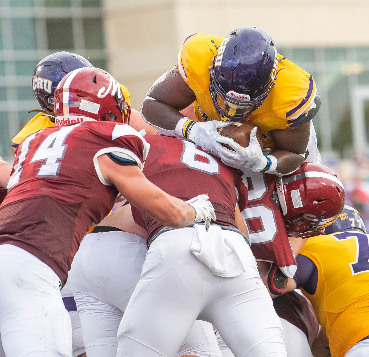 American football players colliding during a tackle in a competitive game