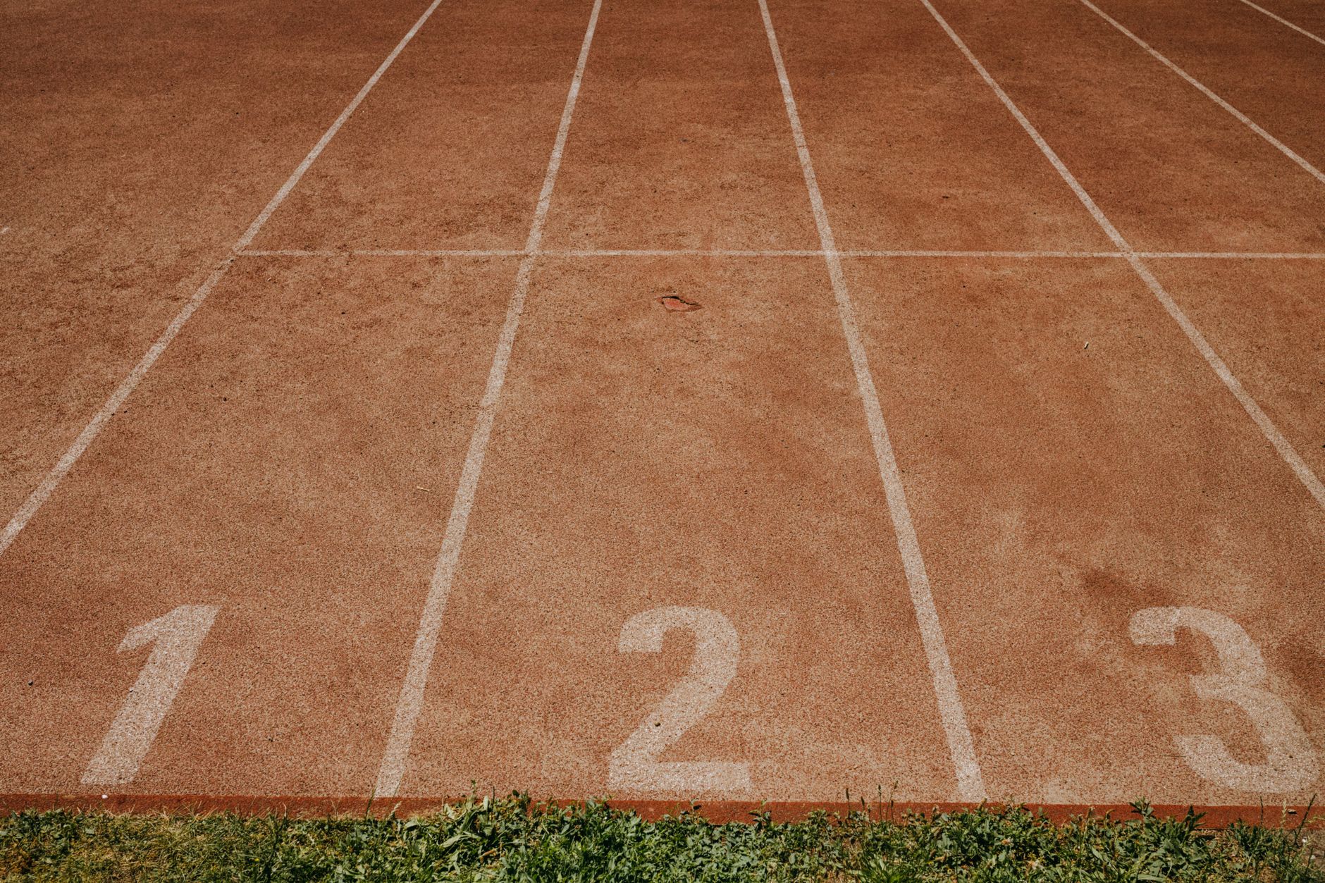 Outdoor sports track with lanes numbered 1 to 3, ready for an athletic event