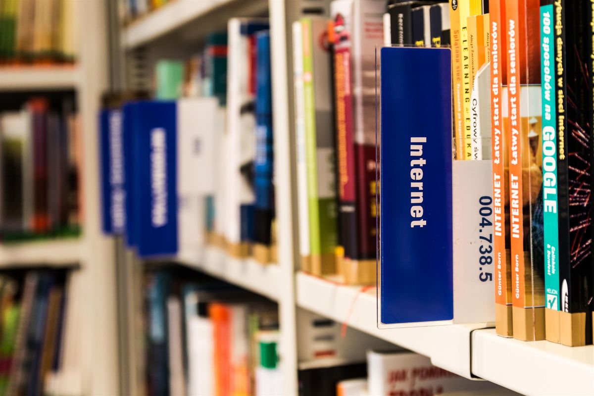 Library shelf with books organised by category labels