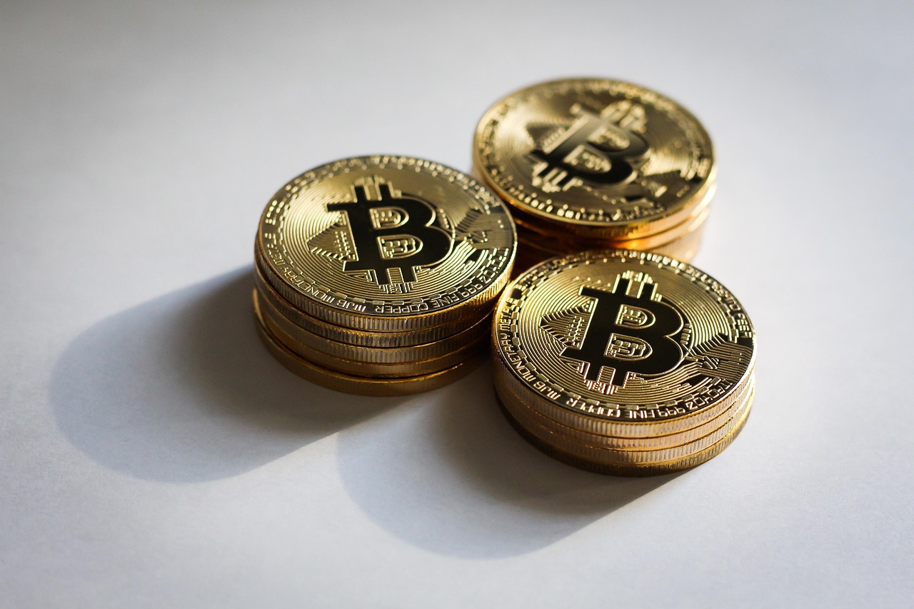 Bitcoin coins and casino chips on a dark table