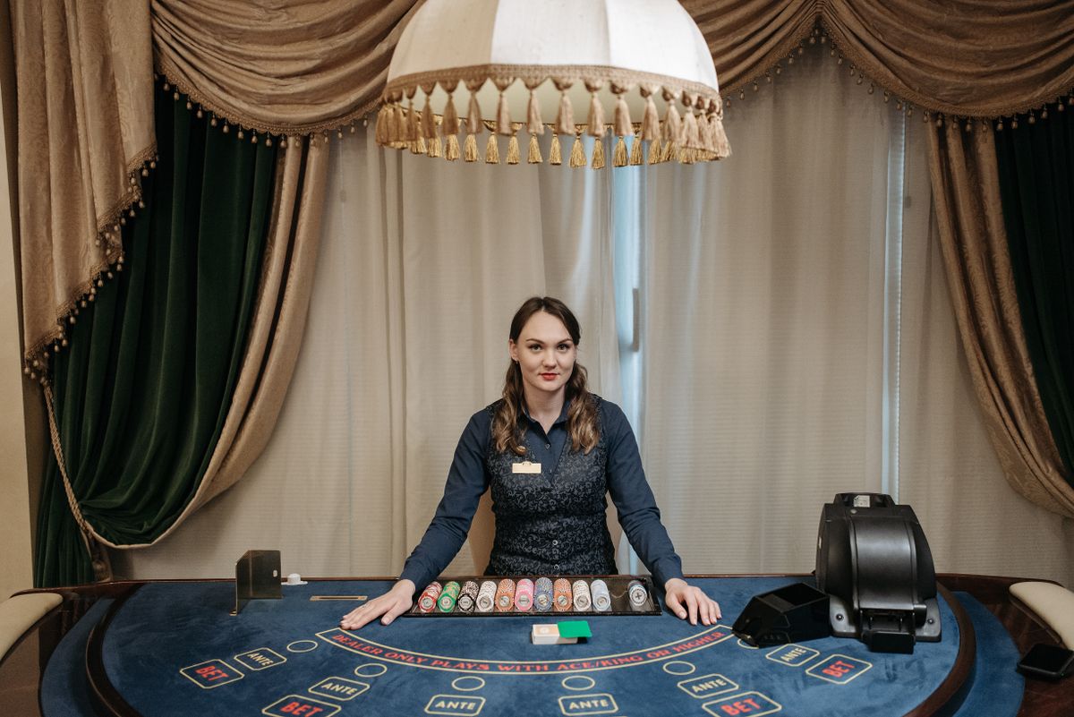 Dealer managing cards and chips at a casino table