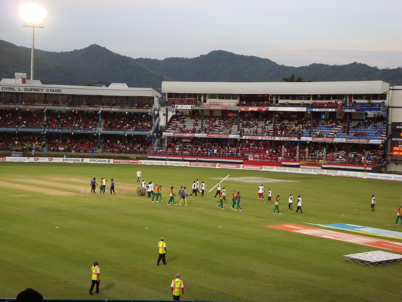 A cricket match in a packed stadium