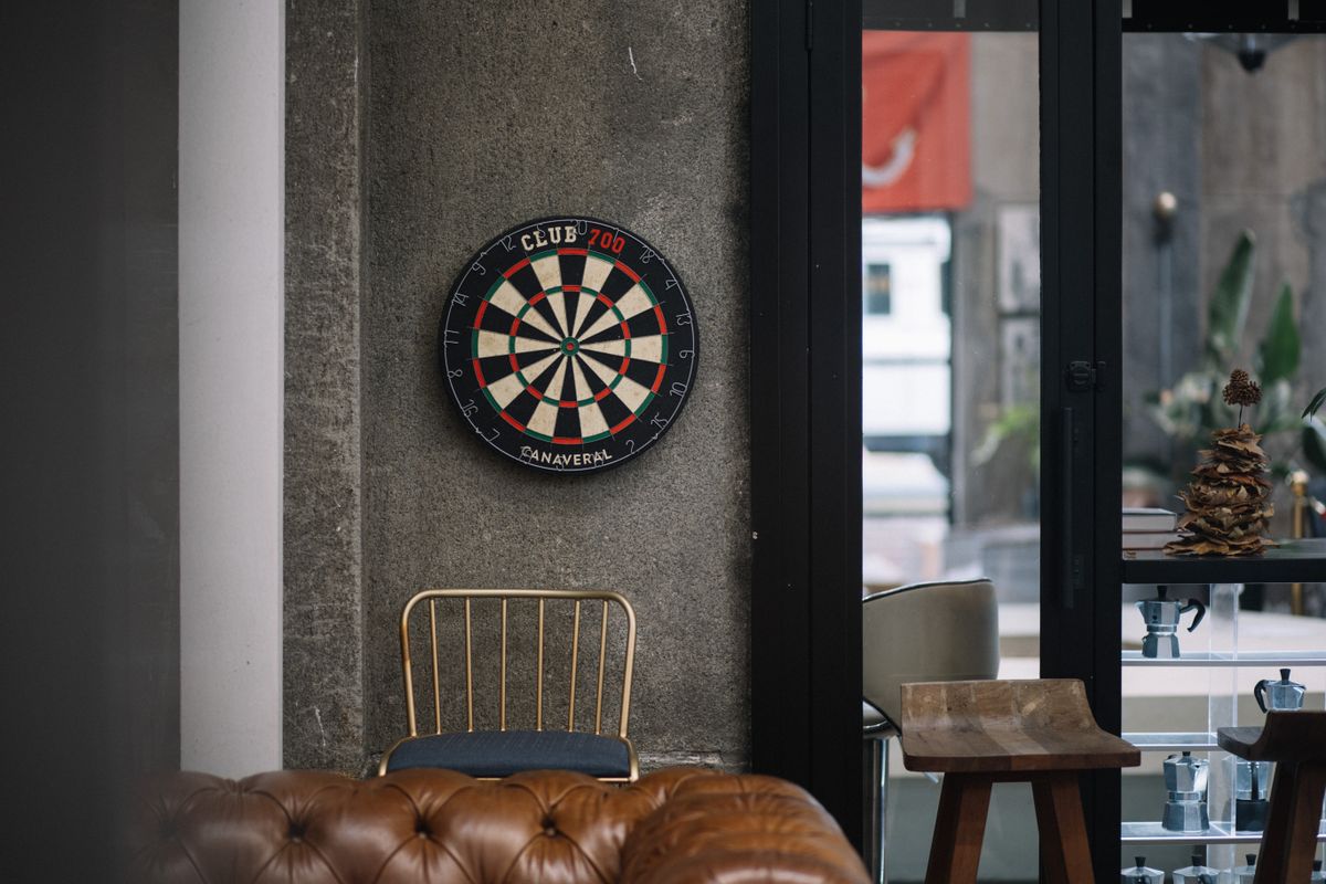 Dartboard mounted on a wall in a bar setting