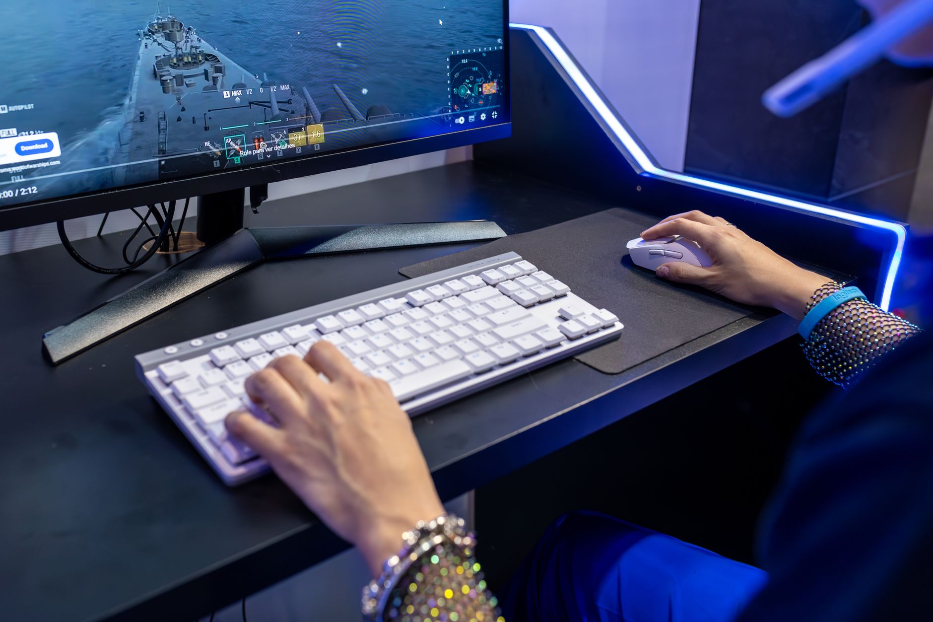 Close-up of a person gaming on a PC with a colorful setup and gaming accessories
