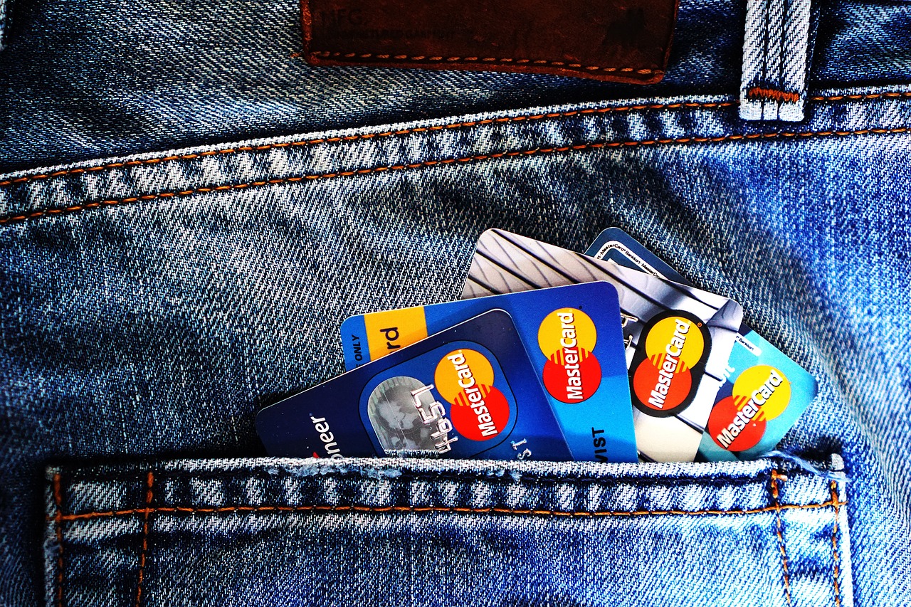 A phone showing a mobile payment screen next to a bank card on a table