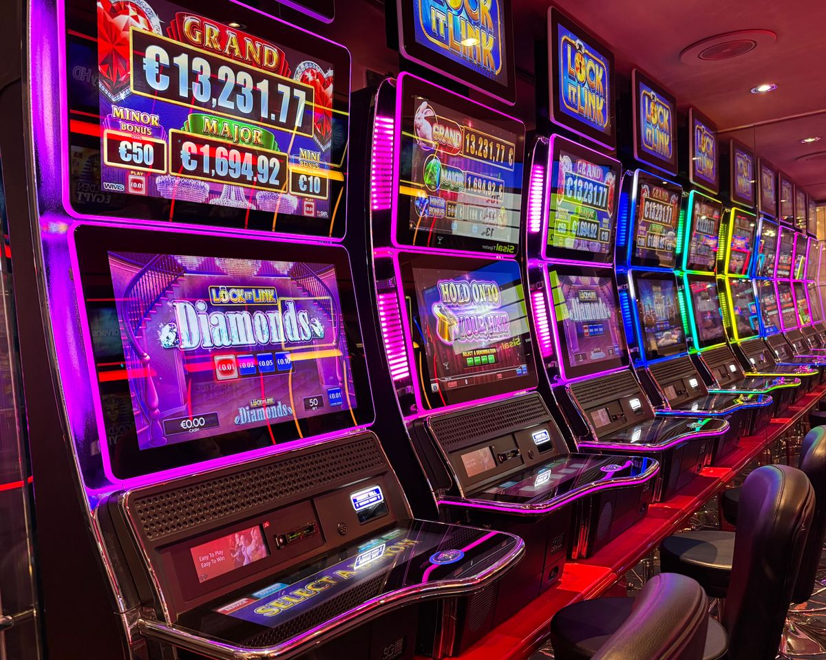 Colourful row of slot machines with neon lights in a casino