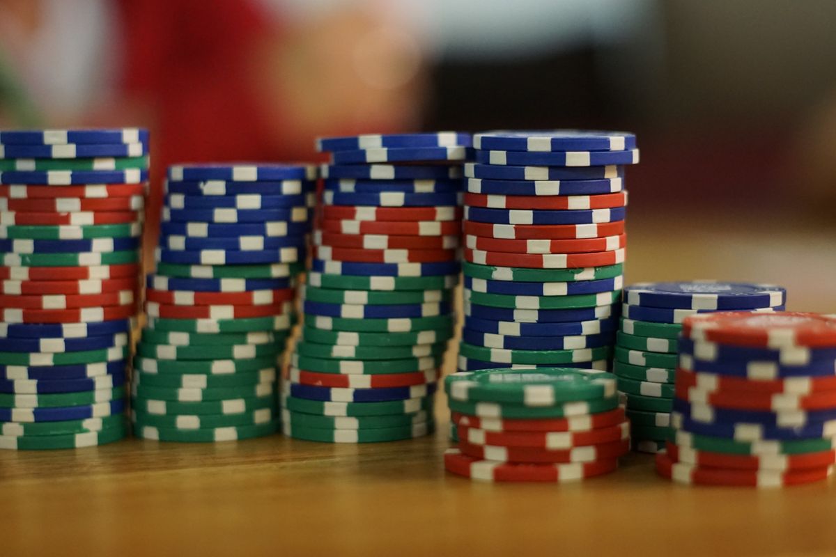 Stacks of colourful poker chips on a wooden table