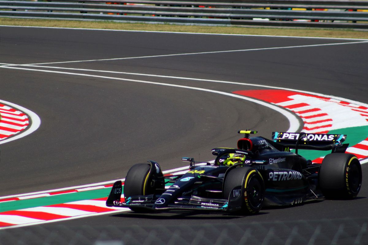 Formula 1 car speeding around a track curve during a race