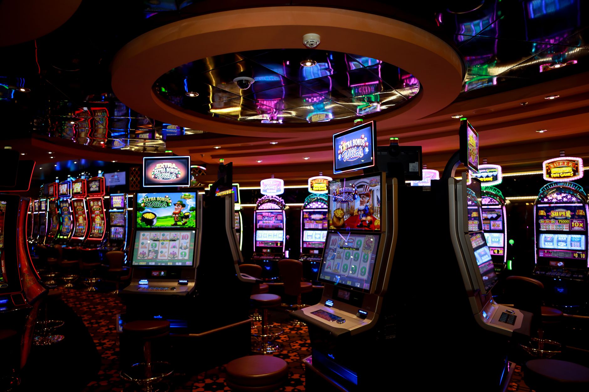 Vibrant casino floor with colorful slot machines and bright lights capturing a lively gaming atmosphere