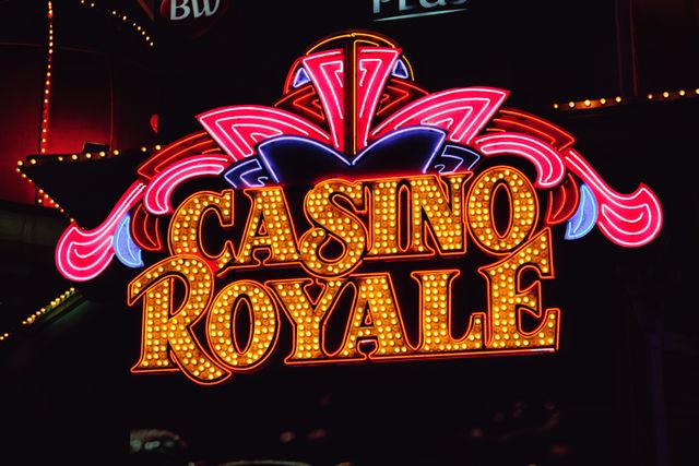 Bright neon casino sign glowing at night against a dark sky