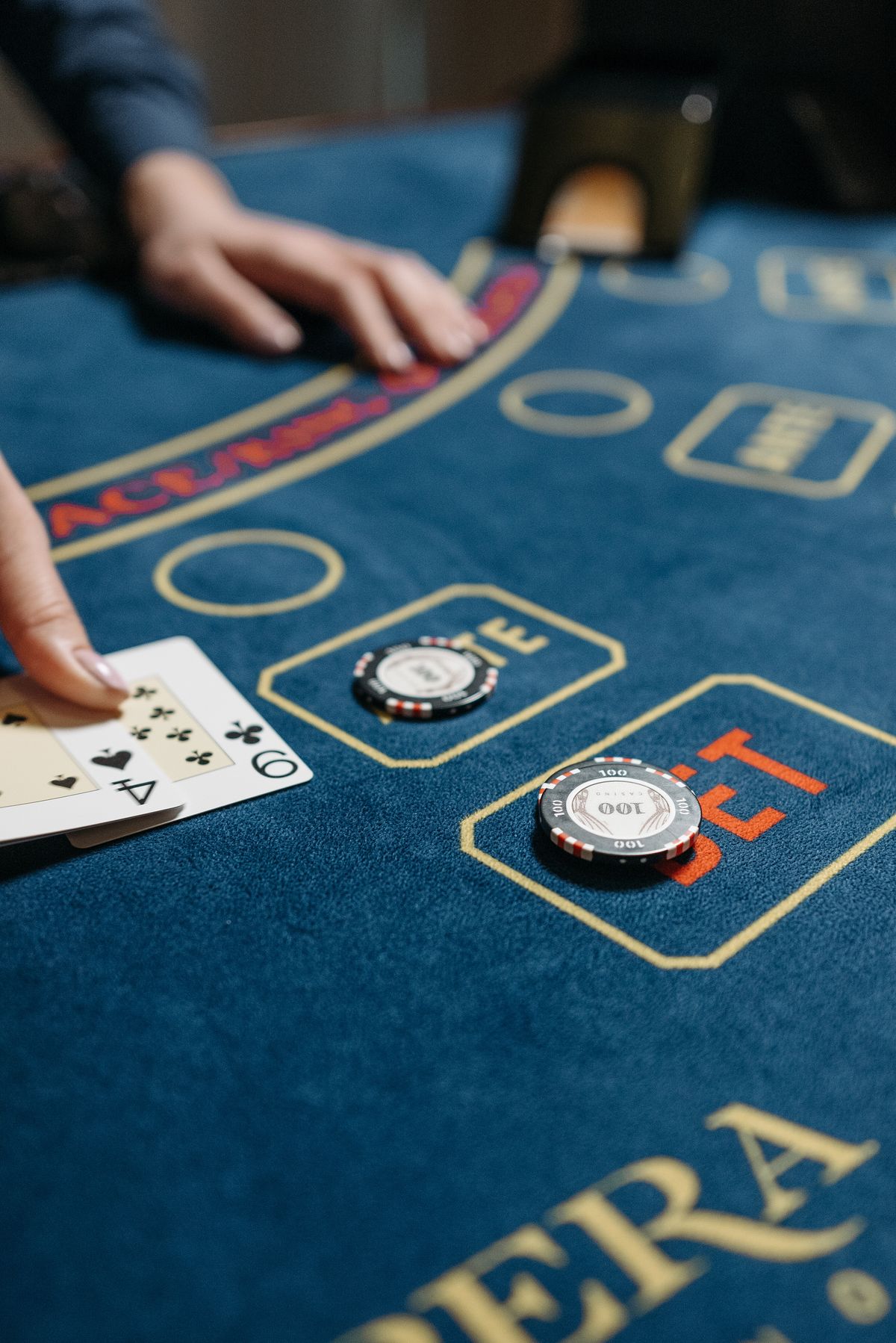 Playing cards and casino chips spread across a green gaming table