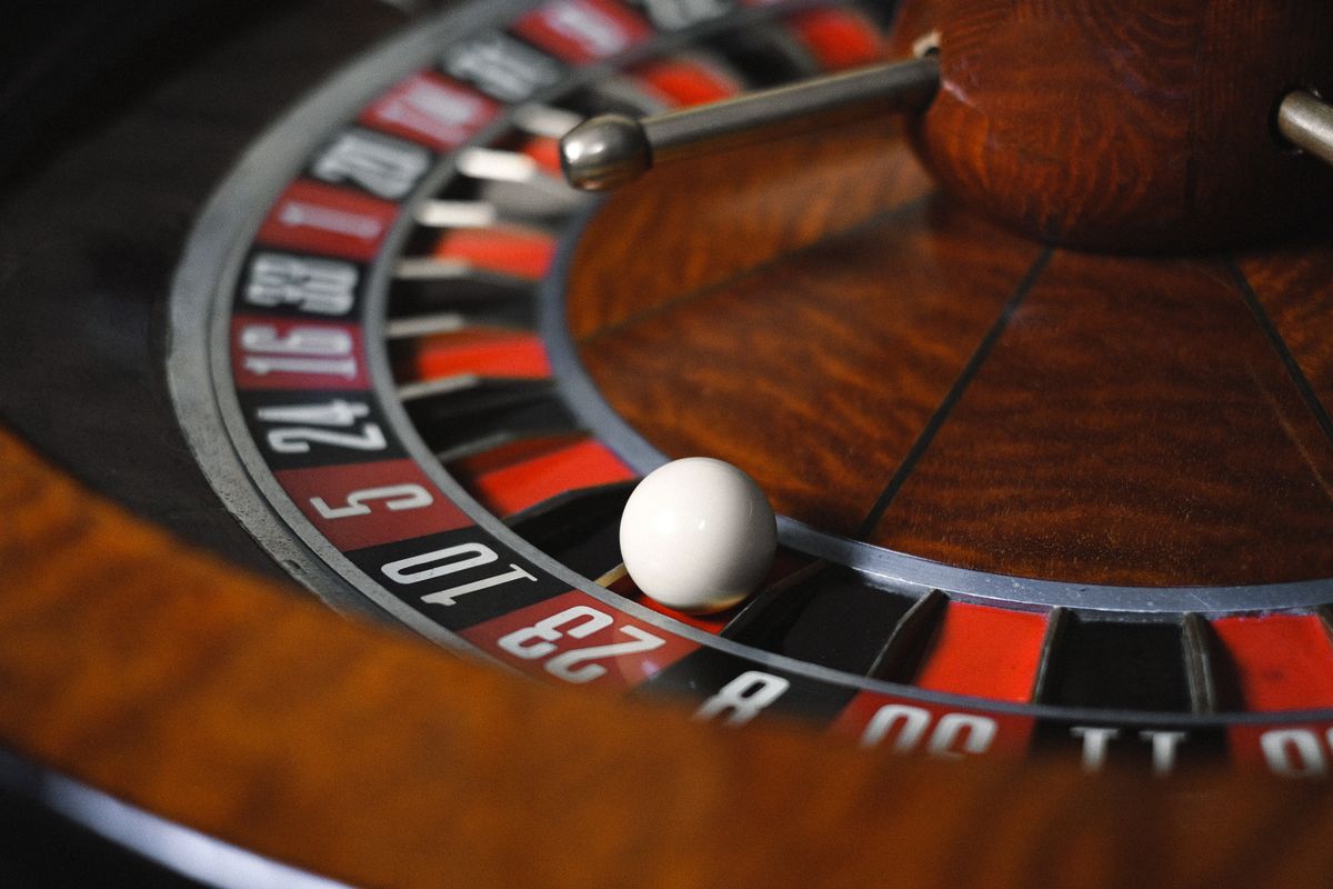 A close-up of a roulette wheel showing numbered pockets and the ball