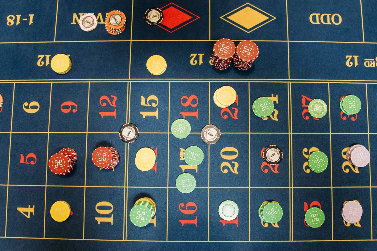 Aerial view of a roulette betting layout with colourful casino chips