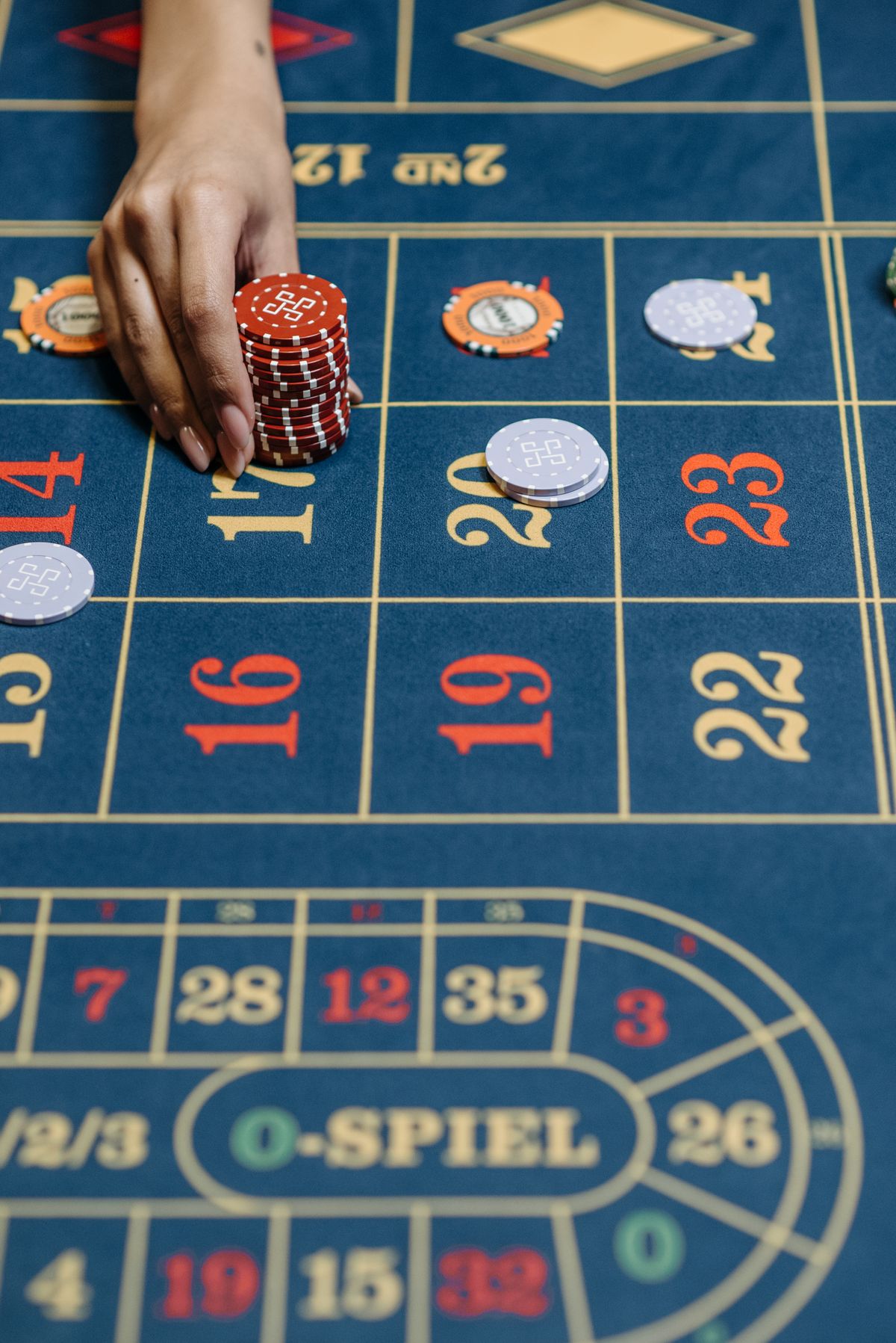 Close up of a roulette wheel spinning with the ball landing on a red number