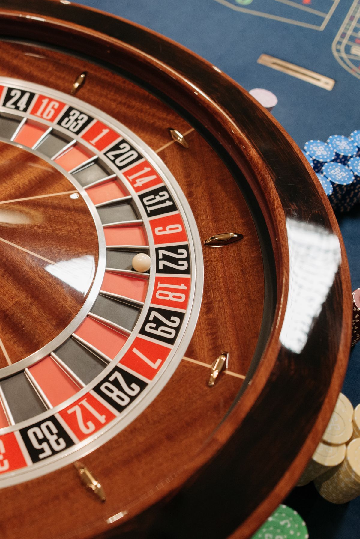 Roulette wheel with poker chips on a table in a casino setting