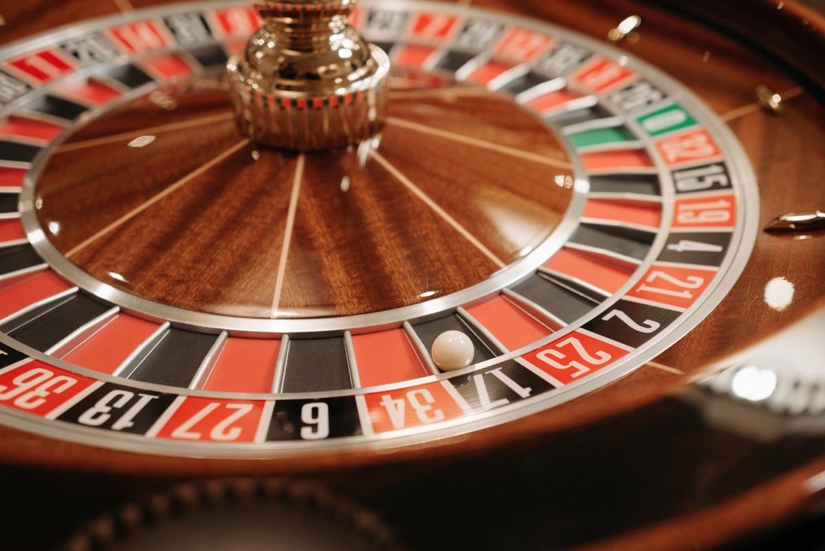 A roulette wheel spinning with the ball in motion on the numbered layout