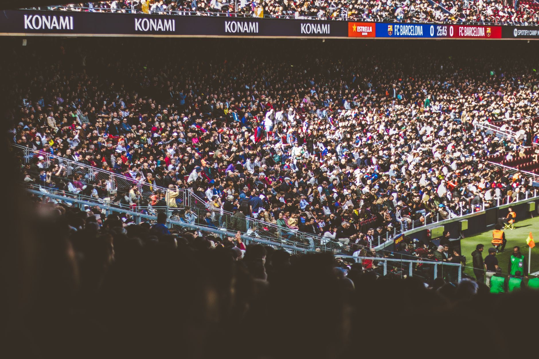 A vibrant crowd fills a football stadium during a lively match