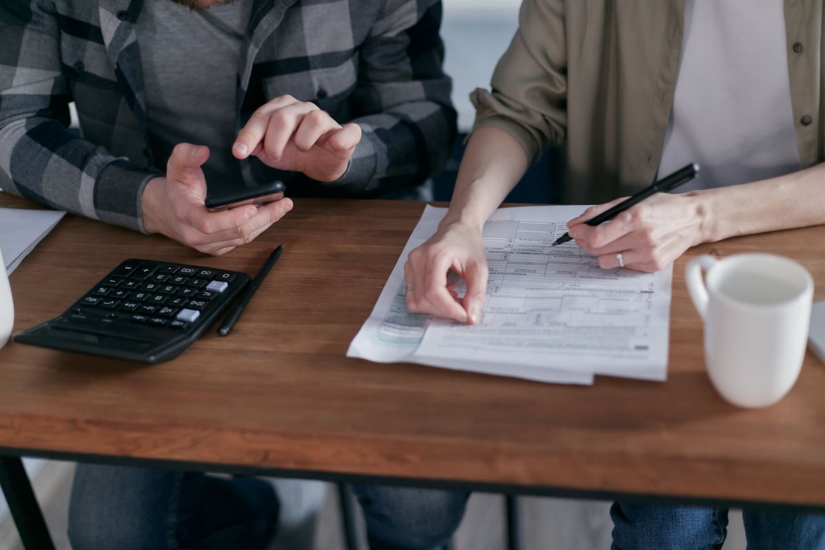 Photograph of a person reviewing bank and mobile-wallet records