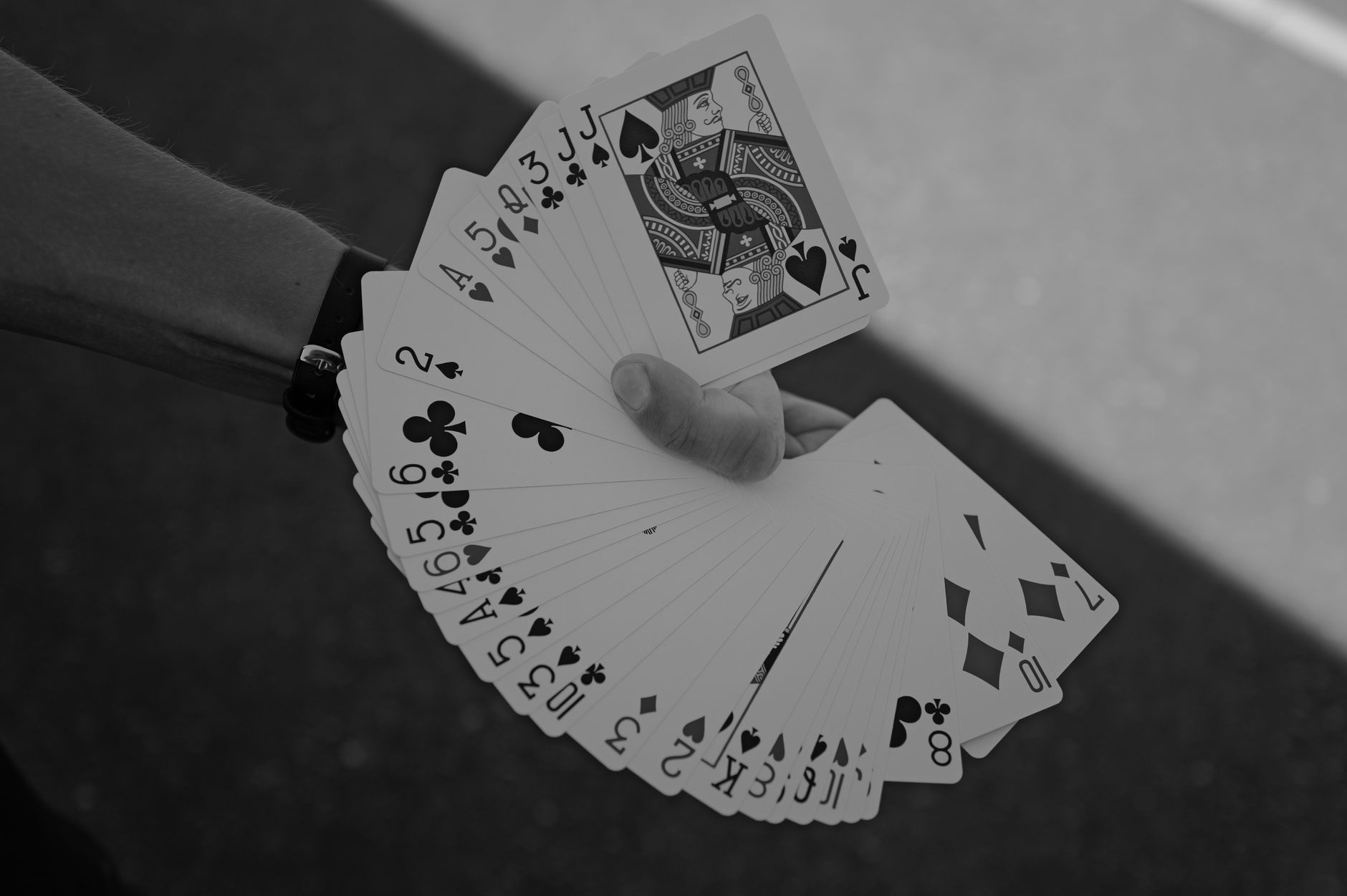 Three playing cards dealt face up on a green felt table surface with a stack of chips beside them