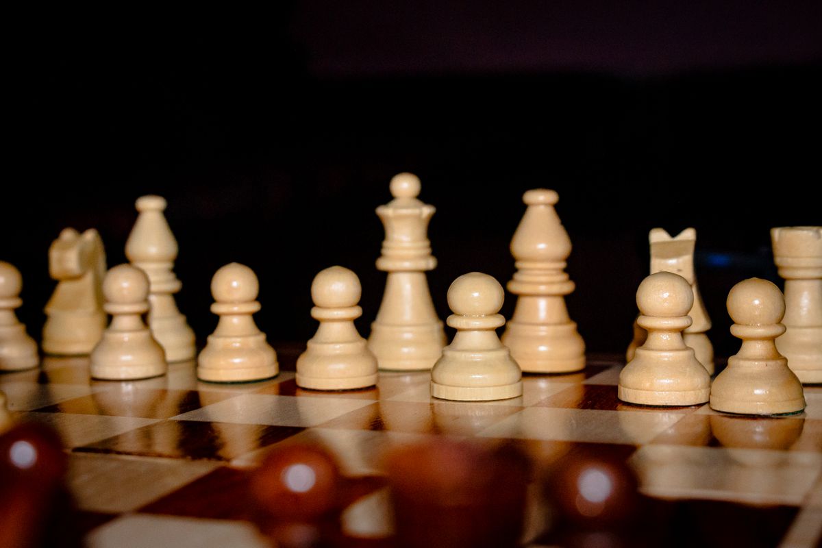 Chess pieces arranged on a board representing strategy and calculation