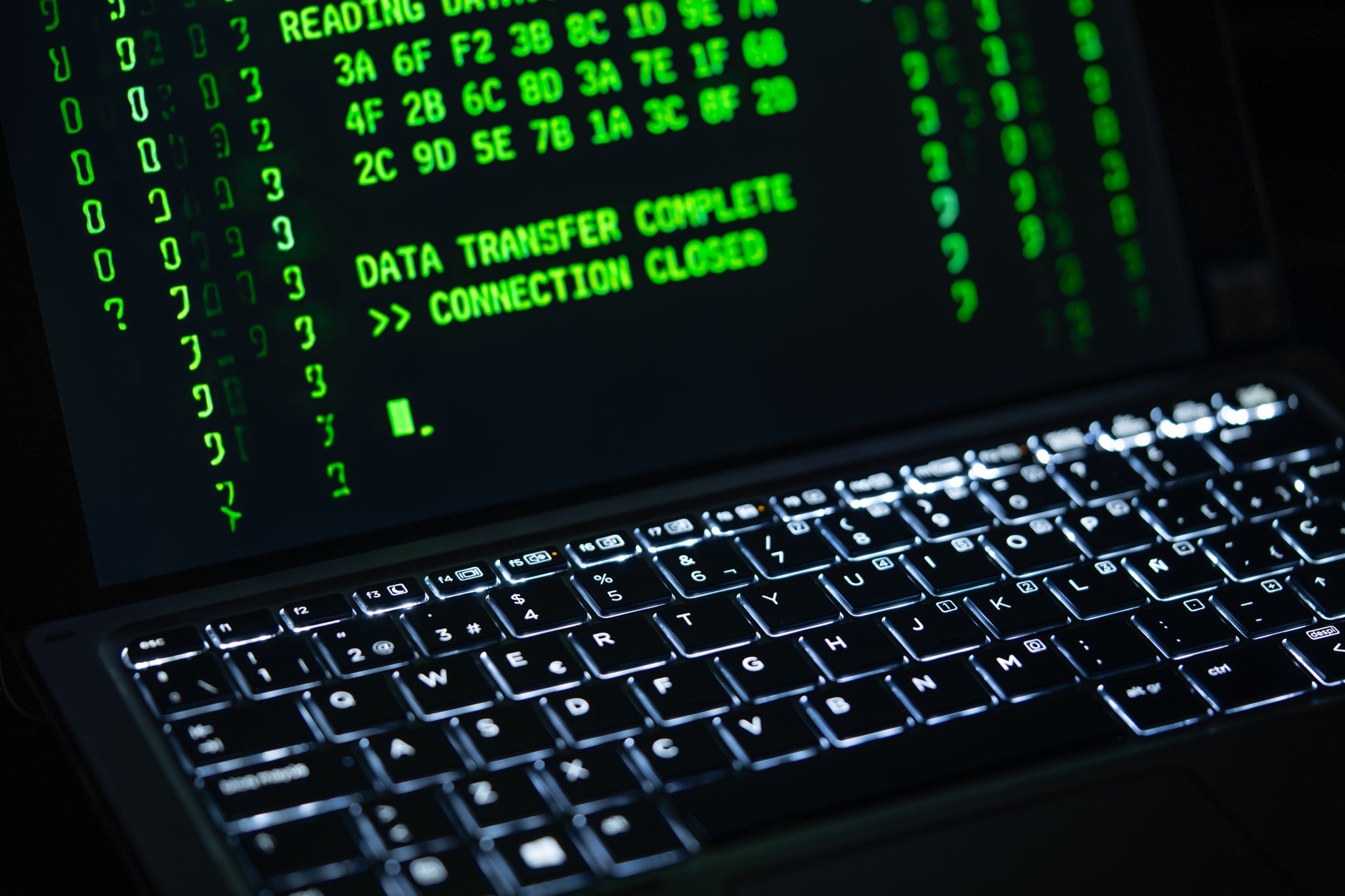 Close-up of a laptop screen displaying green code text. Perfect for cybersecurity themes